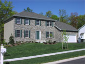 Autumn Builders colonial home with stone front and young landscaping
